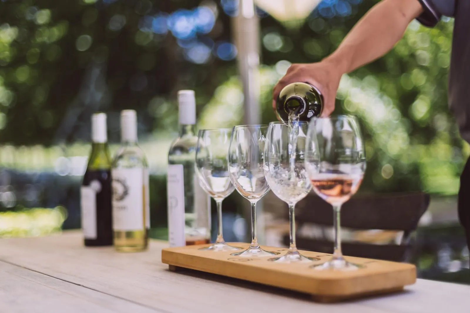 A flight of white and rosé wines being poured at a Franschhoek wine estate