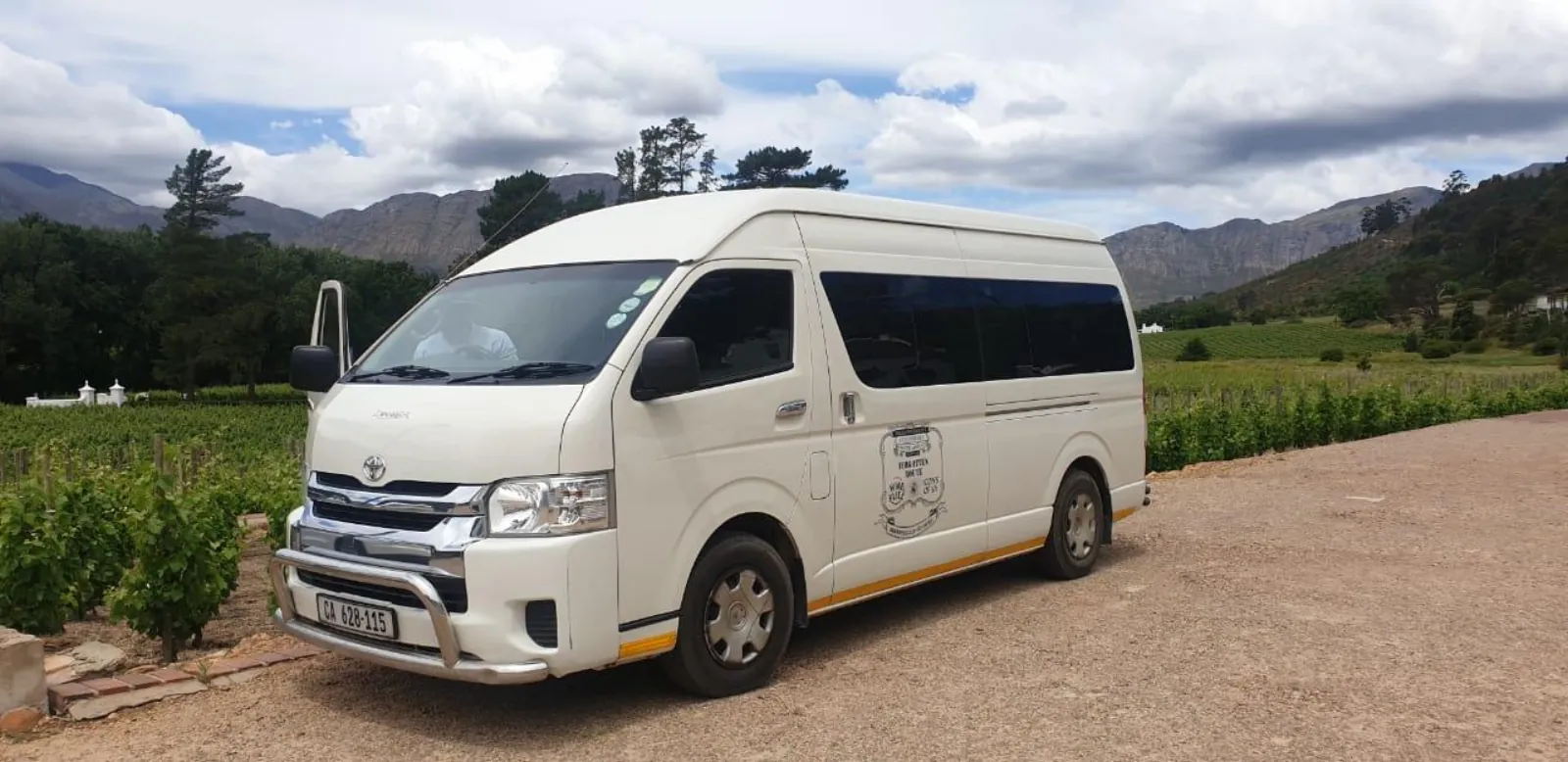 The white minibus used for the Stellenbosch wine tour, parked at an estate