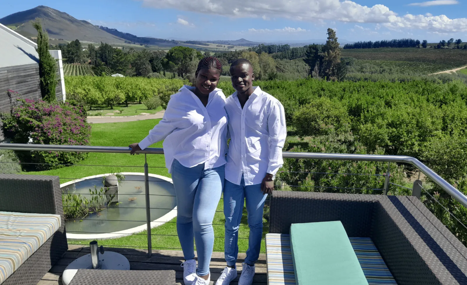 Two visitors on a viewing deck looking out over the Stellenbosch vineyards